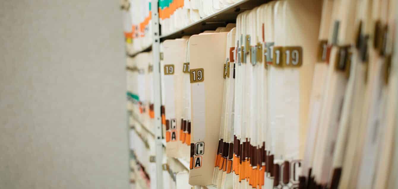 medical record charts on shelve sorted alphabetically